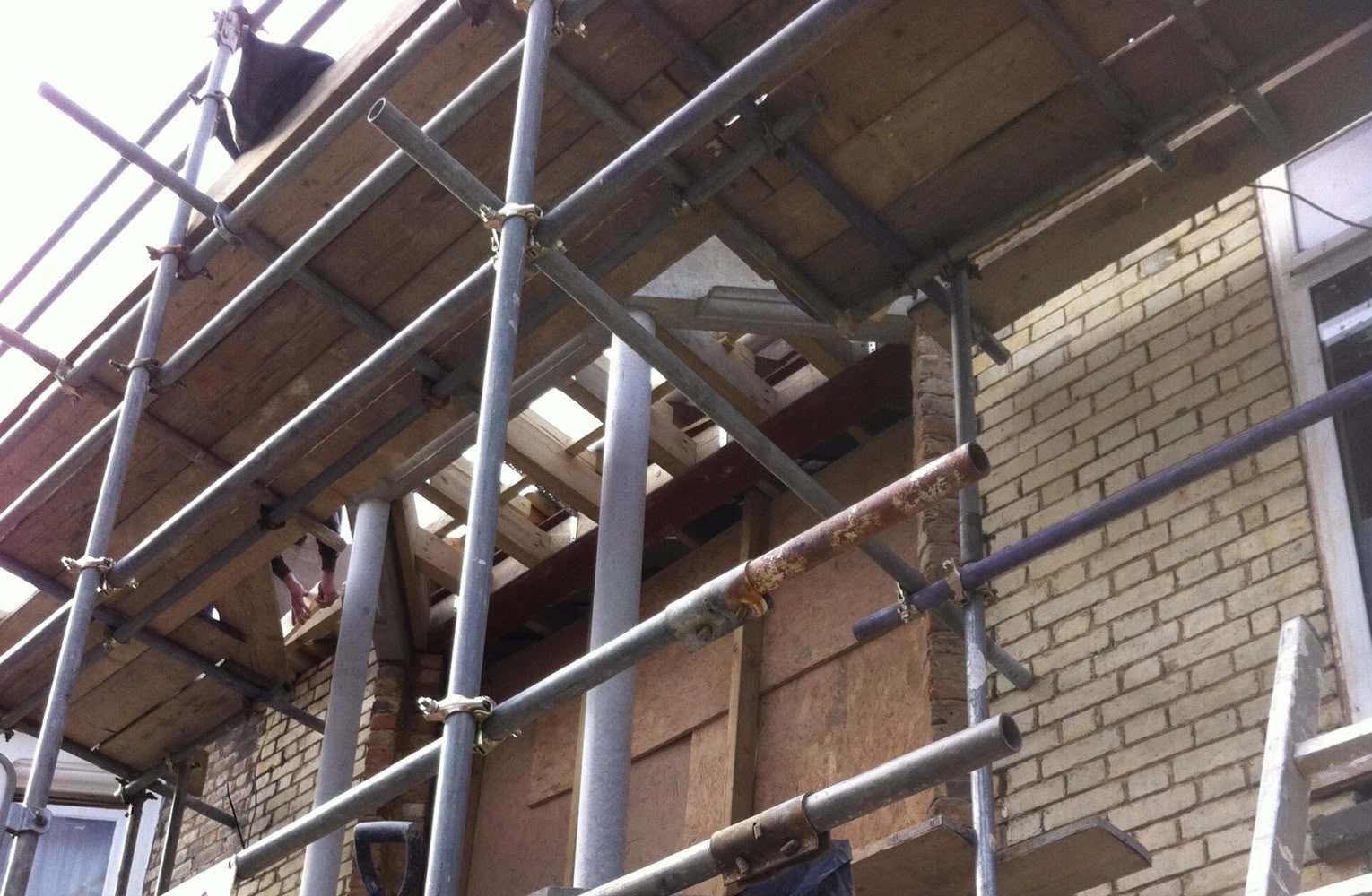 Rear elevation scaffolded with the roof opened up during a conversion