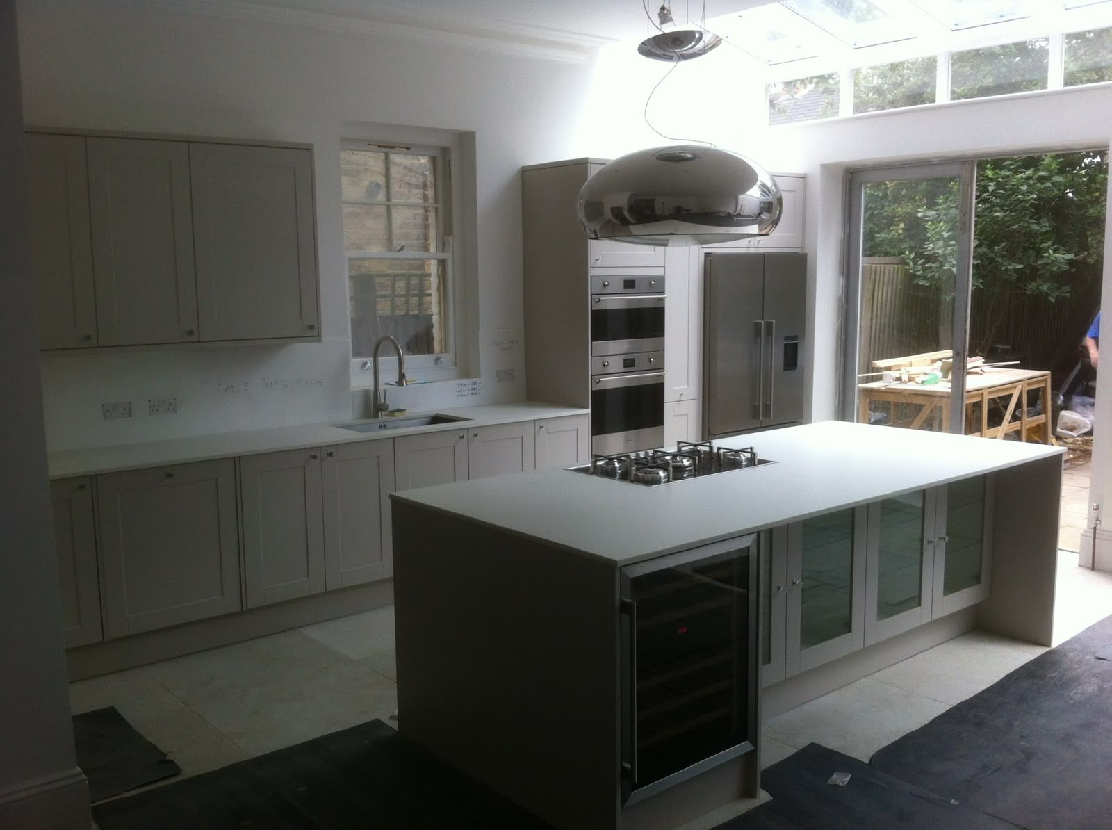 Open plan kitchen renovation with island and roof lantern